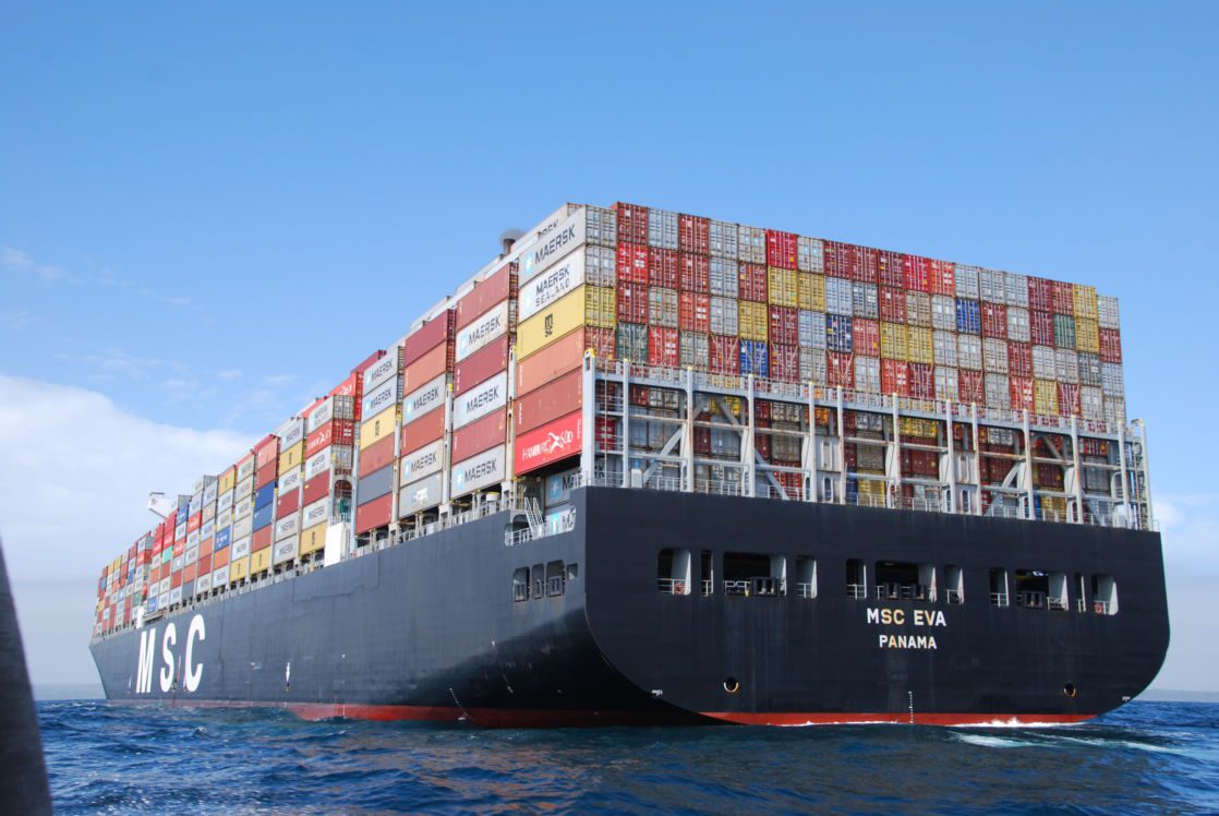 Huge container ship viewed from the stern at sea level