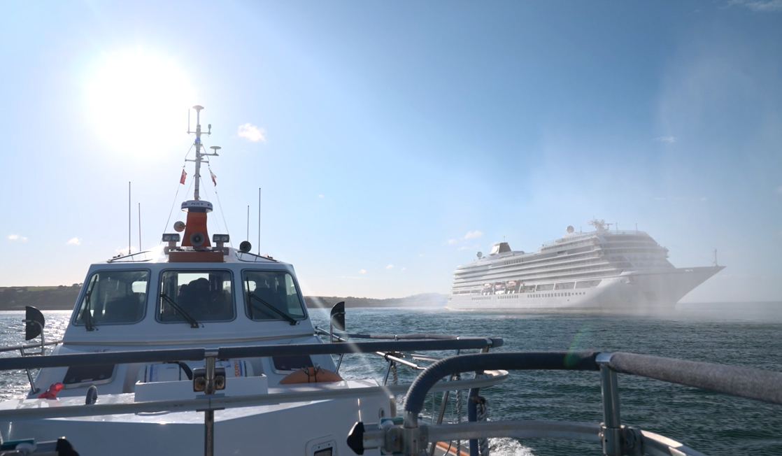 View from bow of pilot boat towards a cruise liner