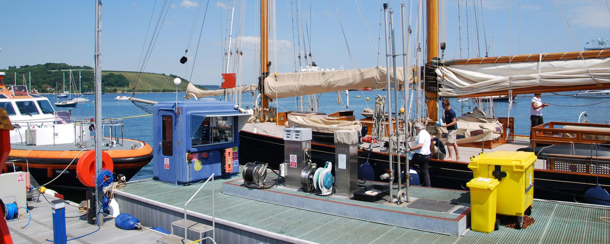 Boat using the fuel pontoon at Falmouth harbour