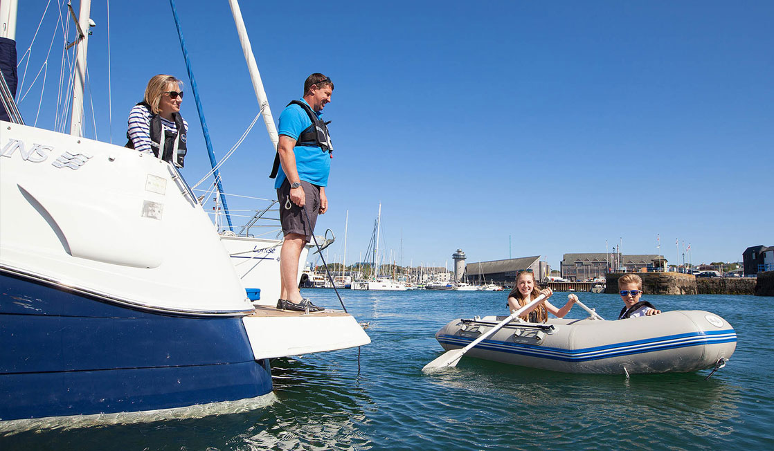 Children in tender by the yacht