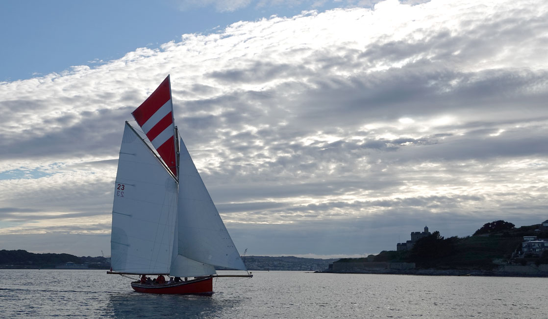 Sail boat with bank of clouds on the horizon