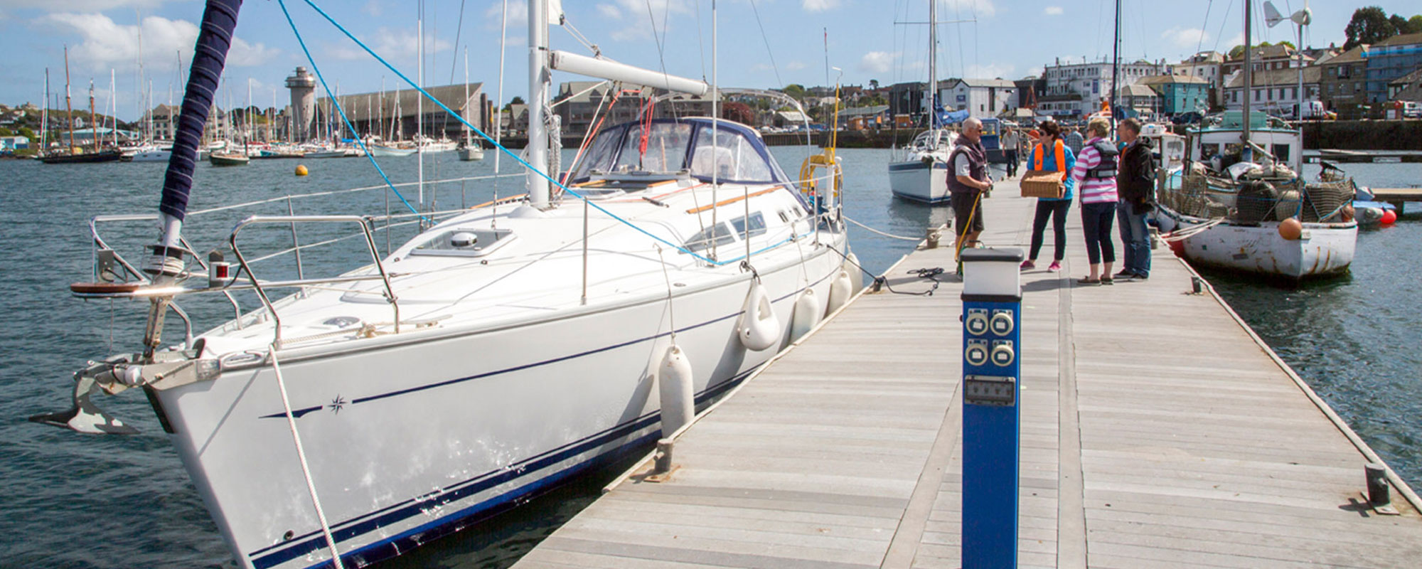 Crew chatting next to a boat on the pontoon