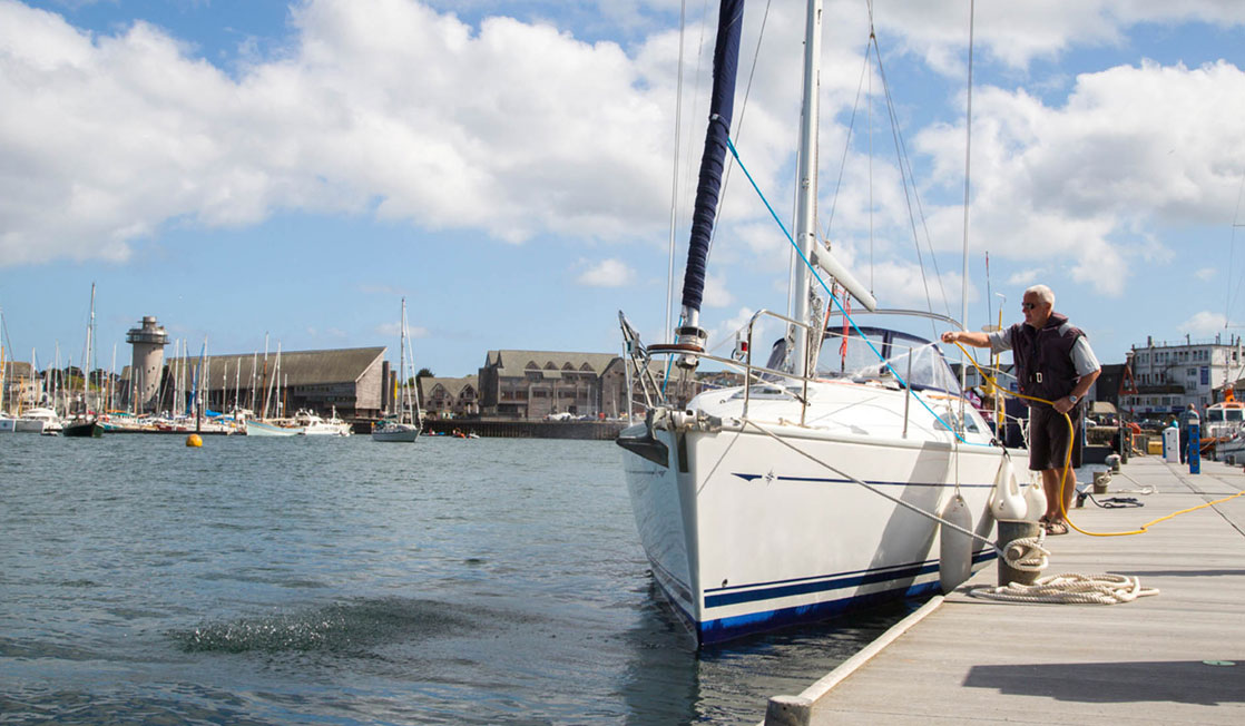 A man washing off a boat at the marina