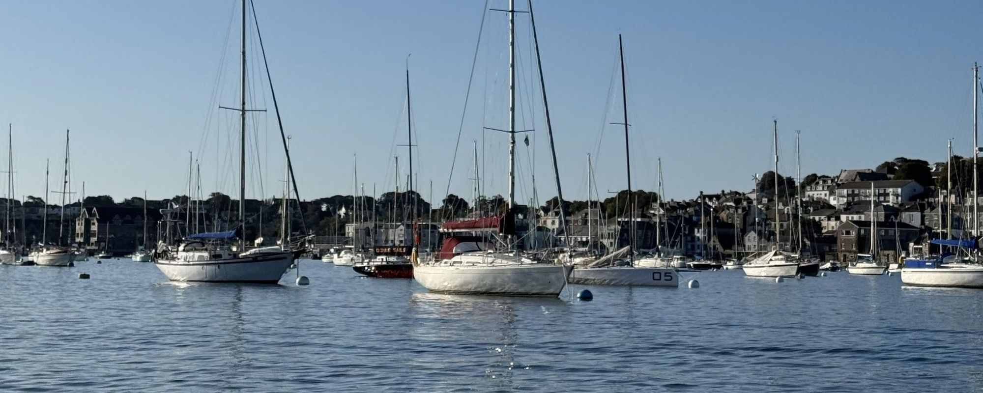 Boats moored in Falmouth harbour on a sunny day