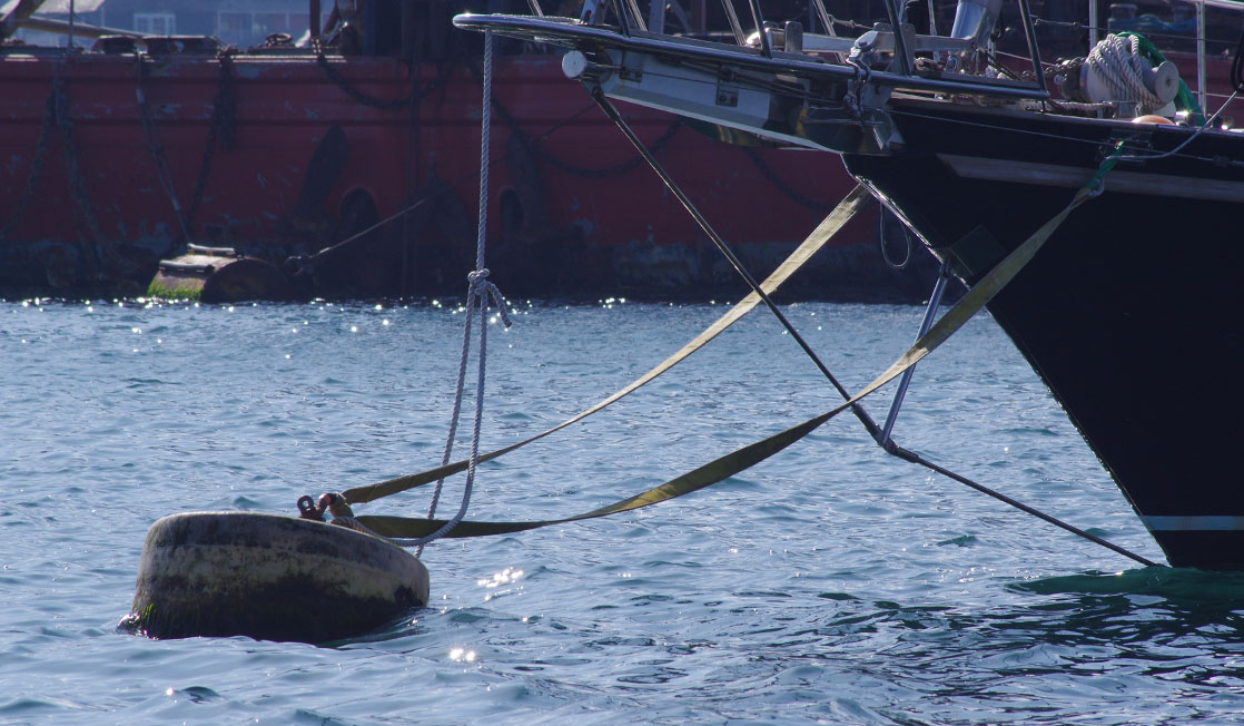 Yacht attached to a mooring buoy