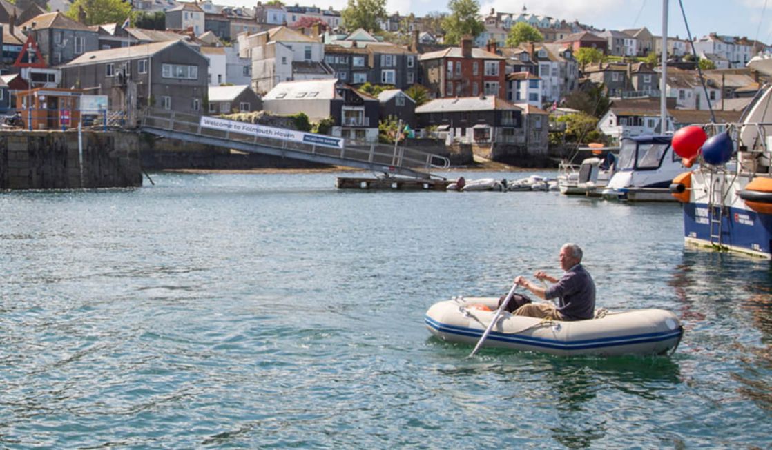 Boat user traveling safely in dingy across the harbour