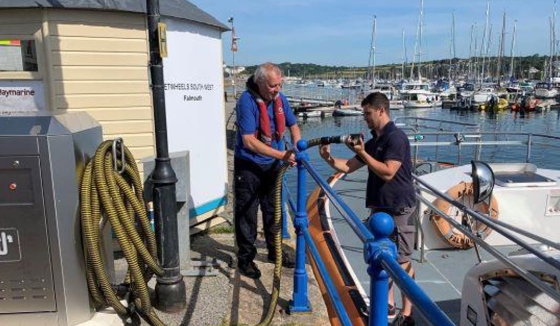 Two people operating the waste facilities on the Falmouth Harbour dock